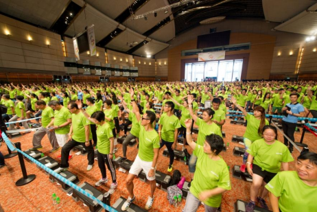 Participants demonstrate great enthusiasm and collaborative spirit in breaking a Guinness World Record by doing step ups simultaneously for over five minutes non-stop